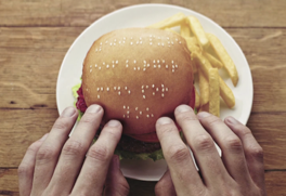 picture of braille on a burger bun using sesame seeds